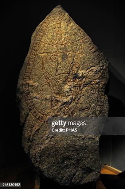 Unna's Rune Stone. Christian cross and serpent with rune writing. Torsatra, Uppland. Historical Museum. Stockholm, Sweden.