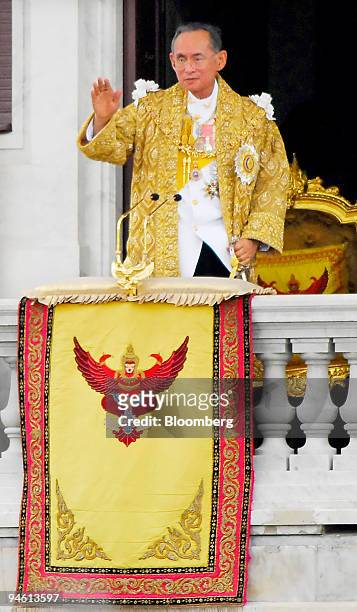 Thai King Bhumibol Adulyadej waves after giving a speech to nearly 1 million Thais from the balcony of the Ananda Samakhon Throne Hall in Bangkok on...