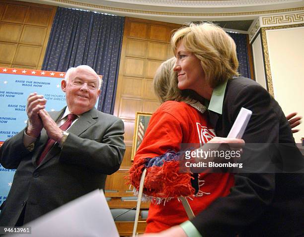 California Representative Betty Sutton, right hugs Gina Walters, center, a 44-year-old mother from Ohio who works for minimum wage as a cashier at a...