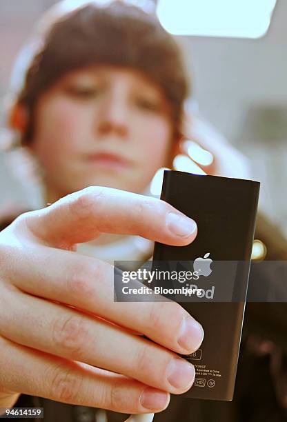 Tyler Johnson listens to a Apple iPod Nano at the Simply Mac store at the University Mall in Orem, Utah Thursday, December 21, 2006.