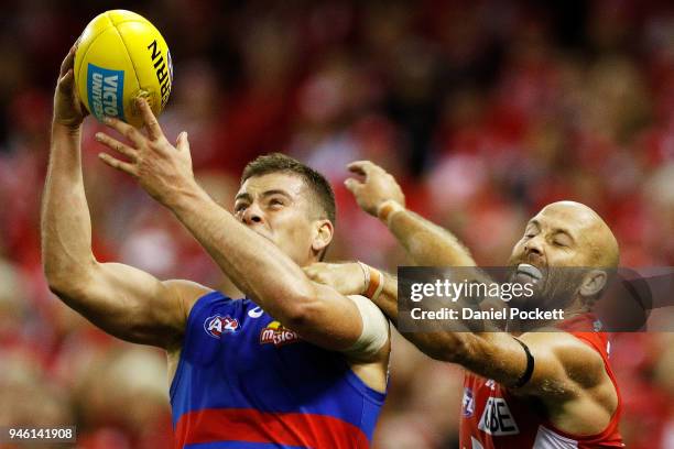 Josh Dunkley of the Bulldogs and Jarrad McVeigh of the Swans contest the ball during the round four AFL match between the Western Bulldogs and the...