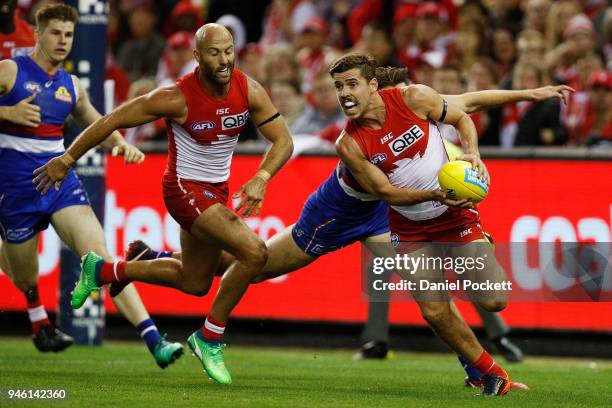 Dane Rampe of the Swans handpasses the ball during the round four AFL match between the Western Bulldogs and the Sydney Swans at Etihad Stadium on...