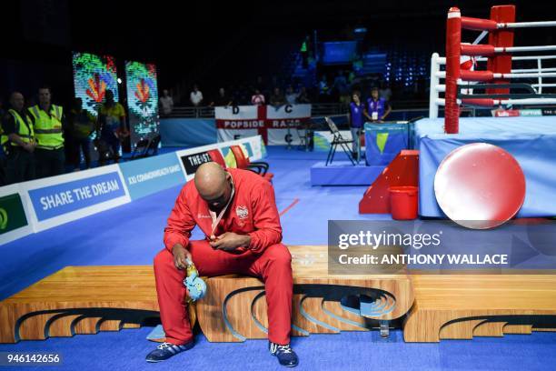 Gold medallist England's Frazer Clarke rests after his win over India's Satish Kumar during their men's +91kg final boxing match during the 2018 Gold...