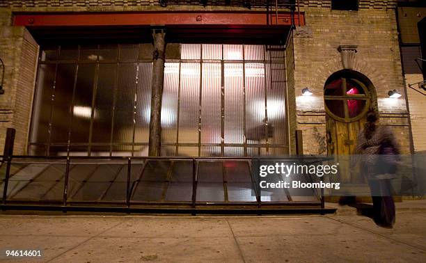 Woman walks past the exterior of Tailor restaurant on Broome Street in New York, U.S., on Monday, Sept. 24, 2007. Tailor, a subversive little...