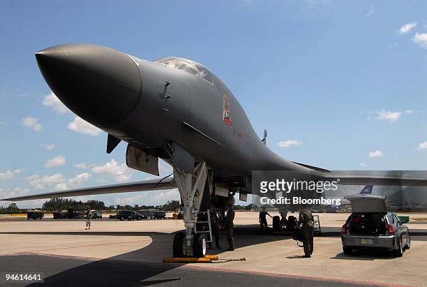 Crew members and support staff gather around a US Air Force B-1 Lancer, a swing-wing, heavy bomber, after it landed in Opa-locka, Florida, Thursday,...