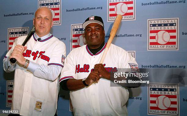 Cal Ripken Jr., left, and Tony Gwynn, former Major League Baseball players, pose with their "Hall of Fame" jerseys and bats during a news conference...