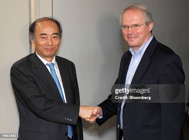 Christopher Hill, U.S. Assistant secretary of state, right, shakes hands with Kenichiro Sasae, bureau chief of Japanese Foreign Ministry's Asian and...