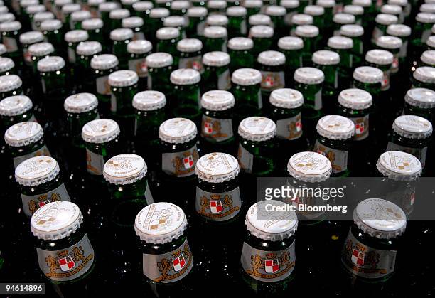 Bottles of Kronenbourg beer sit on the production line at the company's brewery in Obernay, France, on Tuesday, Dec. 18, 2007. Carlsberg A/S Chief...