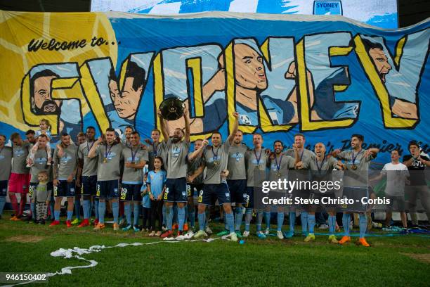 Sydney FC hold up the Premiers Plate after the round 27 A-League match between the Sydney FC and the Melbourne Victory at Allianz Stadium on April...