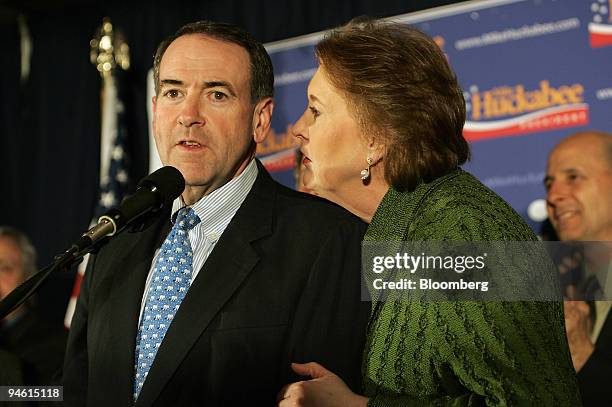 Janet Huckabee, right, whispers to her husband Mike Huckabee, former governor of Arkansas and 2008 Republican presidential candidate, at a primary...