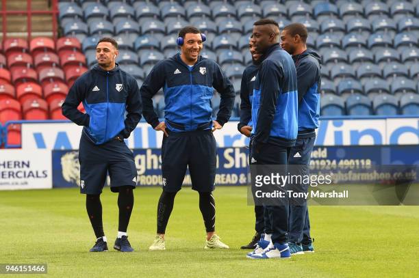 Troy Deeney of Watford speaks to teammates as they inspect the pitch prior to the Premier League match between Huddersfield Town and Watford at John...