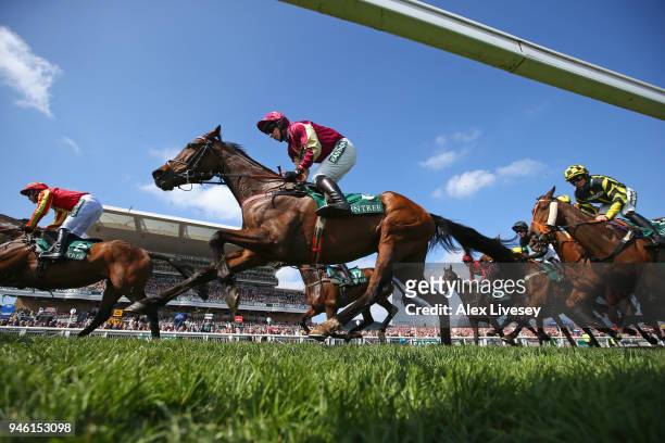 Horses and riders pass the grandstand during the first race the Gaskells Handicap Hurdle Race at Aintree Racecourse on April 14, 2018 in Liverpool,...