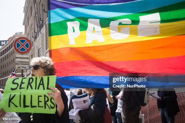 Protester holds a placard during a demonstration against the military action in Syria in front of the US embassy in Rome, Italy, 14 April 2018. USA,...