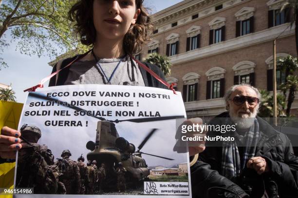 Protester holds a placard during a demonstration against the military action in Syria in front of the US embassy in Rome, Italy, 14 April 2018. USA,...