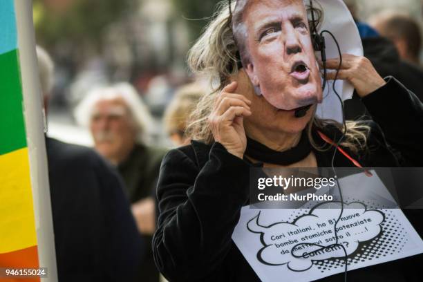 Protester holds a placard during a demonstration against the military action in Syria in front of the US embassy in Rome, Italy, 14 April 2018. USA,...