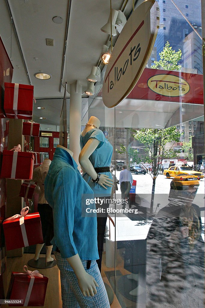 A pedestrian passes by a Talbots display window on Thursday,