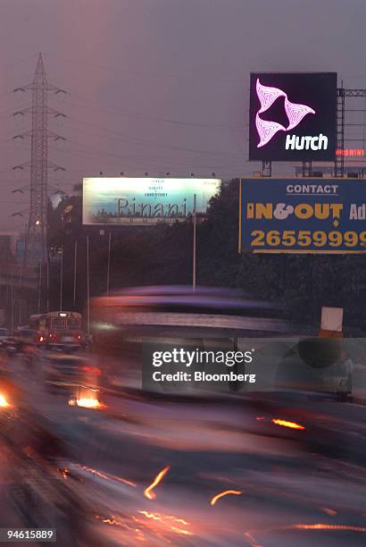 Traffic moves past a neon sign for Hutch in Mumbai, India, on Tuesday, January 9, 2007. Hutchison Whampoa Ltd., billionaire Li Ka- Shing's largest...