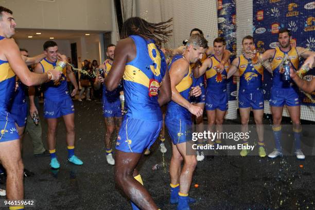 Nic Naitanui of the Eagles celebrates his 150th game and Mark LeCras of the Eagles his 200th game during the round four AFL match between the West...