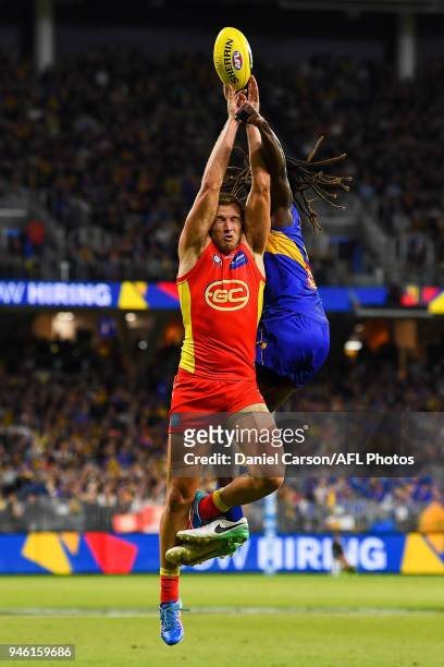 Sam Day of the Suns has his mark attempt spoilt by Nic Naitanui of the Eagles during the 2018 AFL Round 04 match between the West Coast Eagles and...