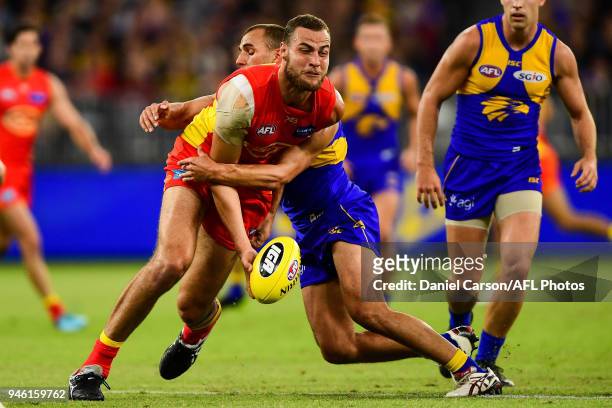 Jarrod Witts of the Suns is tackled by Dom Sheed of the Eagles during the 2018 AFL Round 04 match between the West Coast Eagles and the Gold Coast...