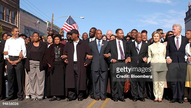 Illinois Senator Barack Obama, far left, former President Bill Clinton, far right, and New York Senator Hillary Clinton link arms with others in the...