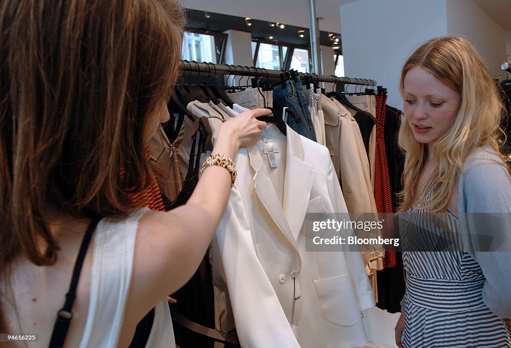 A customer helps another consider a purchase in a Filippa K.