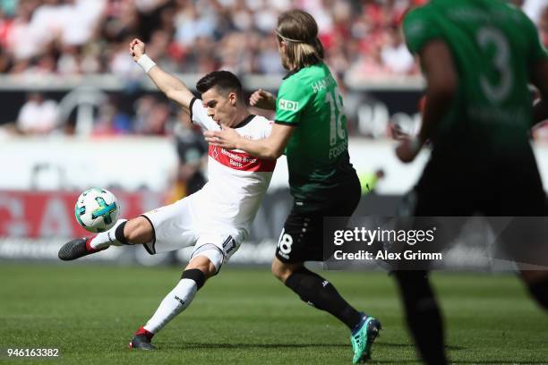 Erik Thommy of Stuttgart is challenged by Iver Fossum of Hannover during the Bundesliga match between VfB Stuttgart and Hannover 96 at Mercedes-Benz...
