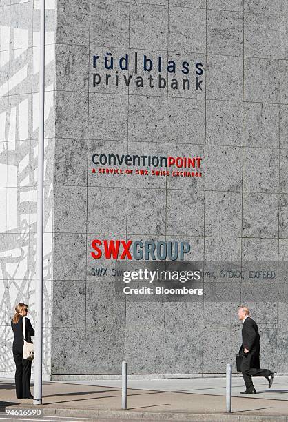 People exit the Swiss Stock Exchange building in Zurich on Wednesday, June 7, 2006. The Swiss stock exchange, which has in the past resisted...