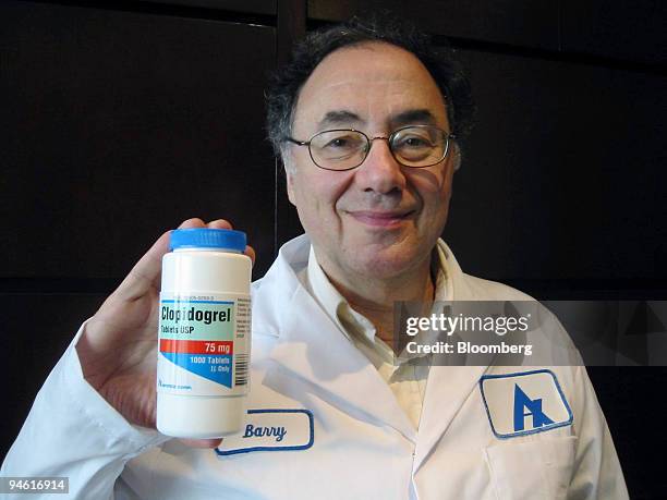 Apotex Inc. Chief Executive Officer Barry Sherman poses with a bottle of clopidogrel tablets, August 14, 2006 at company headquarters in Weston,...