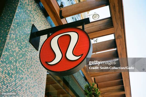 Carved wooden sign on facade of Lululemon yoga and exercise clothing retailer at Broadway Plaza in downtown Walnut Creek, California, February 27,...