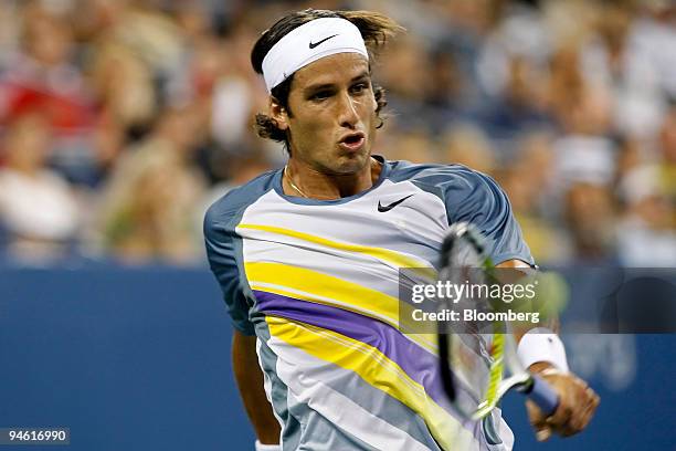 Feliciano Lopez of Spain returns to Roger Federer of Switzerland during their fourth round match on the eighth day of the U.S. Open at the Billie...