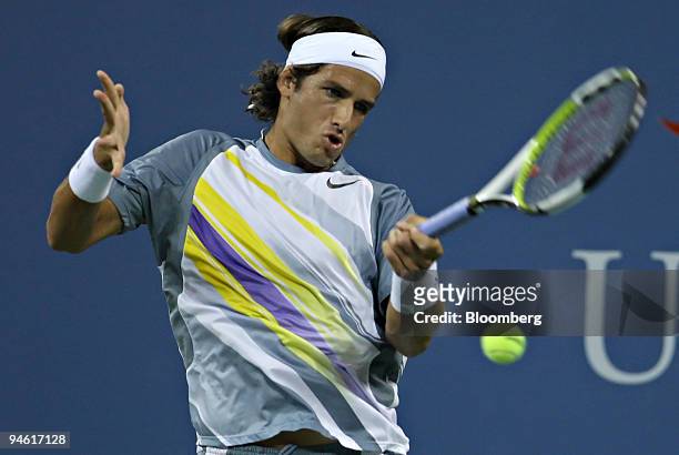 Feliciano Lopez of Spain returns to Roger Federer of Switzerland during their fourth round match on the eighth day of the U.S. Open at the Billie...