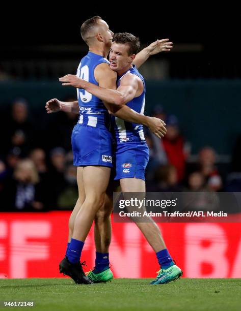 Billy Hartung of the Kangaroos celebrates with Kayne Turner of the Kangaroos during the 2018 AFL Round 04 match between the North Melbourne Kangaroos...