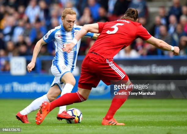 Alex Pritchard of Huddersfield Town is challenged by Sebastian Prodl of Watford during the Premier League match between Huddersfield Town and Watford...