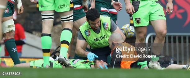 Rob Horne of Northampton Saints receives attention after being knocked out during the Aviva Premiership match between Leicester Tigers and...