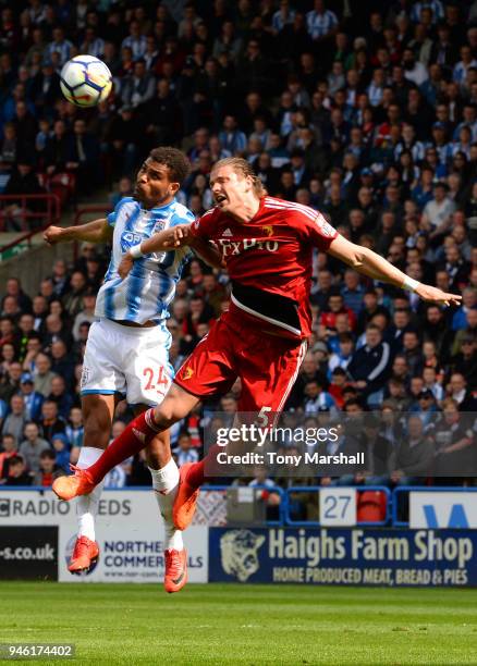 Steve Mounie of Huddersfield Town competes for a header with Sebastian Prodl of Watford during the Premier League match between Huddersfield Town and...