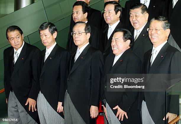 Yasuo Fukuda, newly elected prime minister of Japan, foreground center, poses with his cabinet members during a photo session after their first...