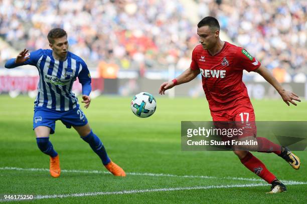 Christian Clemens of Koeln runs with Mitchell Weiser of Berlin during the Bundesliga match between Hertha BSC and 1. FC Koeln at Olympiastadion on...