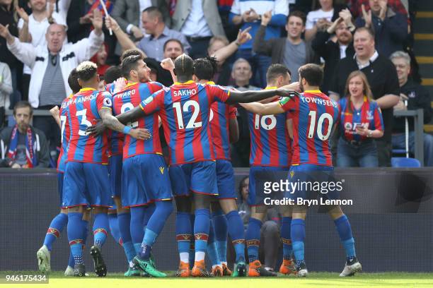 Wilfried Zaha of Crystal Palace celebrates with teammates after scoring his sides first goal during the Premier League match between Crystal Palace...