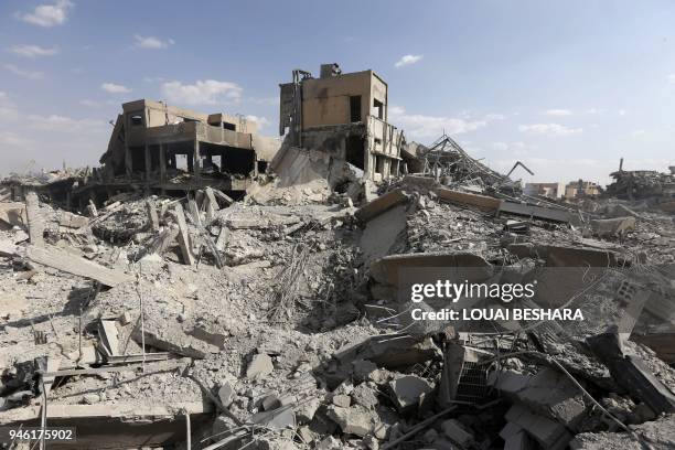 This picture taken on April 14, 2018 shows the wreckage of a building described as part of the Scientific Studies and Research Centre compound in the...