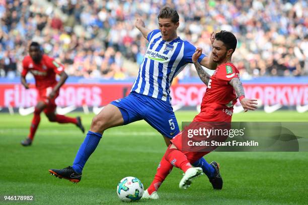 Niklas Stark of Berlin runs with Leonardo Bittencourt of Koeln during the Bundesliga match between Hertha BSC and 1. FC Koeln at Olympiastadion on...