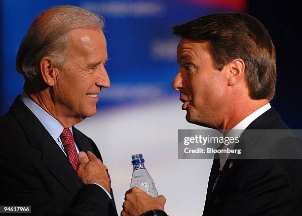John Edwards, former senator from North Carolina, right, speaks with Joe Biden, senator from Delaware, during a break in a debate for Democratic...