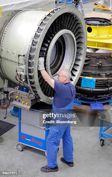 Worker assembles an aircraft jet engine at the MTU Aero engines factory in Ludwigsfelde, Germany, Wednesday, August 23, 2006.