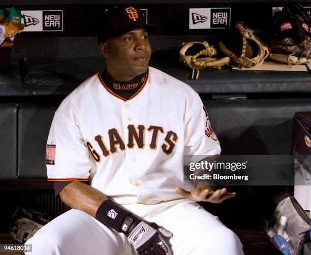 Barry Bonds, professional baseball player with the San Francisco Giants, sits in the dugout in the first inning of a baseball game against the San...