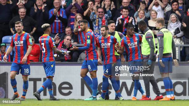 Wilfried Zaha of Crystal Palace celebrates with teammates after scoring his sides third goal during the Premier League match between Crystal Palace...