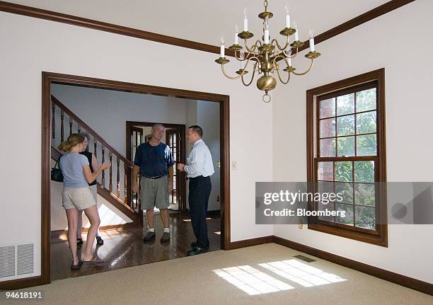 Two couples talk in the foyer of a home for sale in Powell, Ohio, Tuesday, Aug. 22, 2006. At left is Katie Mathews with her husband, Dan, at right....