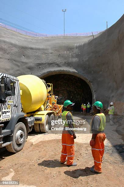 Workers stand in front of a tunnel through which the Gautrain underground railway will run, in Marlboro, Johannesburg, South Africa, Thursday, Mar 1,...