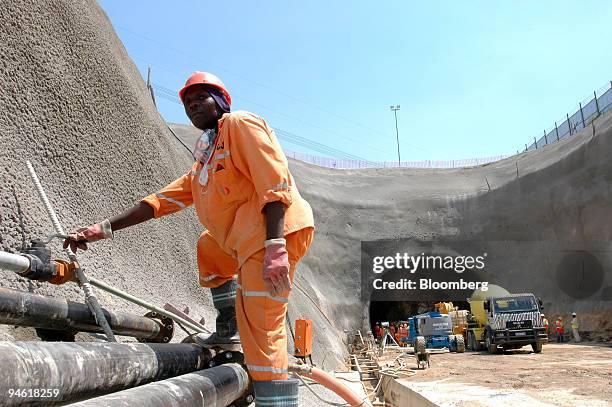 Worker controls the flow of cleaning air to a tunnel through which the Gautrain underground railway will run, in Marlboro, Johannesburg, South...