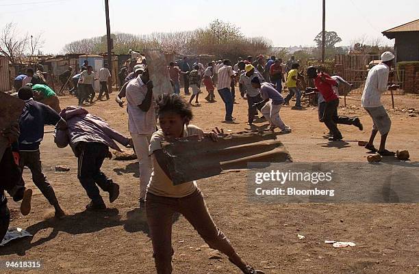 Residents battle with police in a protest against poor service delivery in the fields of water, electricity, housing, sanitation and health in the...