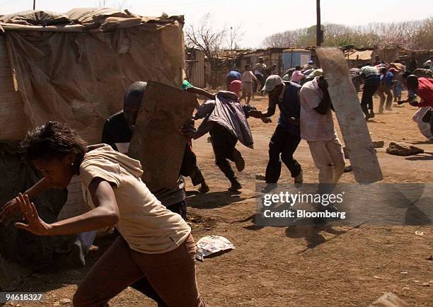 Residents battle with police in a protest against poor service delivery in the fields of water, electricity, housing, sanitation and health in the...